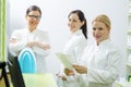 Three pretty female pharmacists at work posing