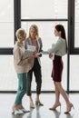 three professional businesswomen talking