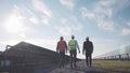 Three professionals in solar power station. Royalty Free Stock Photo