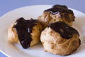 Three Profiteroles on a plate Royalty Free Stock Photo