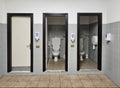 three public toilets, three doors adjacent to three toilets Royalty Free Stock Photo