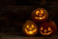 Three pumpkin Jack-O-Lantern with happy faces.