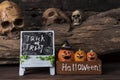 Three pumpkins in the box with trick or treat board Royalty Free Stock Photo