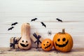 Three pumpkins with painted faces, gift boxes and decorative sp Royalty Free Stock Photo