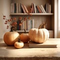 three pumpkins sitting on a book on a table Royalty Free Stock Photo