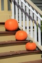 Three pumpkins on steps of rural country home Royalty Free Stock Photo