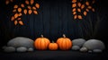 Three pumpkins and stones against a dark background with autumn leaves Royalty Free Stock Photo