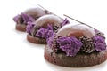 Three purple chocolate desserts with shiny mirror glaze and fresh blackberries Royalty Free Stock Photo