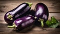 Three purple eggplants on a wooden table Royalty Free Stock Photo