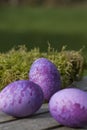 Three purple eggs lying on a table Royalty Free Stock Photo