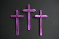 Three purple wooden cross in black background. Christian faith, holy week or lent season celebration concept. Royalty Free Stock Photo