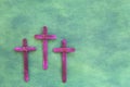 Three purple wooden cross in green background. Holy week and lent season celebration concept. Royalty Free Stock Photo