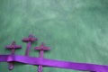 Three purple wooden cross in green background. Holy week and lent season celebration concept. Royalty Free Stock Photo