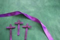 Three purple wooden cross in green background. Holy week and lent season celebration concept. Royalty Free Stock Photo