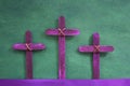 Three purple wooden cross in green background. Holy week and lent season celebration concept. Royalty Free Stock Photo