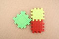 Three puzzle pieces in red, yellow, and green Royalty Free Stock Photo