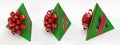 Three pyramidal green gift box with red ribbon