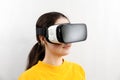 Three-quarter portrait close-up of a young woman wearing virtual reality glasses. White background. The concept of virtual reality Royalty Free Stock Photo