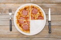 Three quarters - Pizza pieces series as illustration of division in maths on wood table Royalty Free Stock Photo