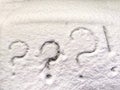 Three question and exclamation marks written in the snow. The cold frosty texture of the snow and the question mark Royalty Free Stock Photo
