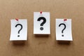 Three question marks pinned to a notice board Royalty Free Stock Photo