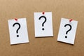 Three question marks pinned on a wooden board Royalty Free Stock Photo