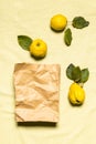 Three quince apples and paper bag flat lay