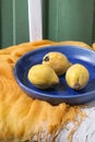 Three quinces in blue ceramic plate