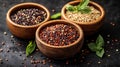 Three quinoa varieties in wooden bowls on dark background Royalty Free Stock Photo