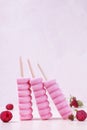 Three raspberry ice cream popsicles