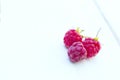 Three raspberry on the wooden table