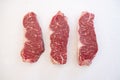 Three Raw Beef Strip Loins Steak Arranged Side by Side