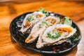 Three raw juicy oyster freshly opened and served on dish at Japanese restaurant. Fresh seafood famous menu