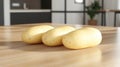 Three raw potatoes on a wooden kitchen table Royalty Free Stock Photo