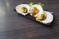 Three raw scallops on teriyaki sauce, copy space on the table Royalty Free Stock Photo