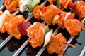 Three raw shaslik skewers on a cooking grate with reflections on Royalty Free Stock Photo