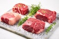 three raw steaks garnished with herb rub on marble slab Royalty Free Stock Photo