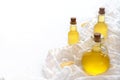 Three raw vegetable oils in a beautiful glass bottle on a white tablecloth and background cedar sunflower and olive