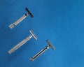 Three razors on blue background. View from above Royalty Free Stock Photo