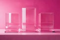 Three rectangle glass fixtures in magenta tints sit on a pink shelf Royalty Free Stock Photo