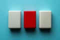 Three rectangular blocks with one red among two white blocks against a blue background Royalty Free Stock Photo