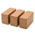 Three rectangular brown bricks or blocks arranged in a row on a white background Royalty Free Stock Photo