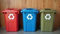 Three recycling bins red blue and green stand in a row. Each bin features a white recycling symbol. These containers are for Royalty Free Stock Photo