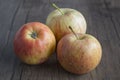 Three red apple on wooden background