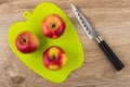 Three red apples on green cutting board, kitchen knife Royalty Free Stock Photo