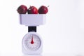 Three red apples on weighing scales Royalty Free Stock Photo