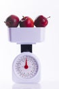 Three red apples on weighing scales Royalty Free Stock Photo