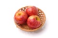 Three red apples in a wicker basket isolated on a white background Royalty Free Stock Photo