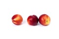 Three red bald peaches on white background. Peaches closeup red color.