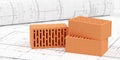 Three red brick stones on architectural building construction plan background and drawing plan roll, construction or masonry or Royalty Free Stock Photo